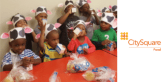 Children eating and drinking milk at CACFP & SFSP meal service