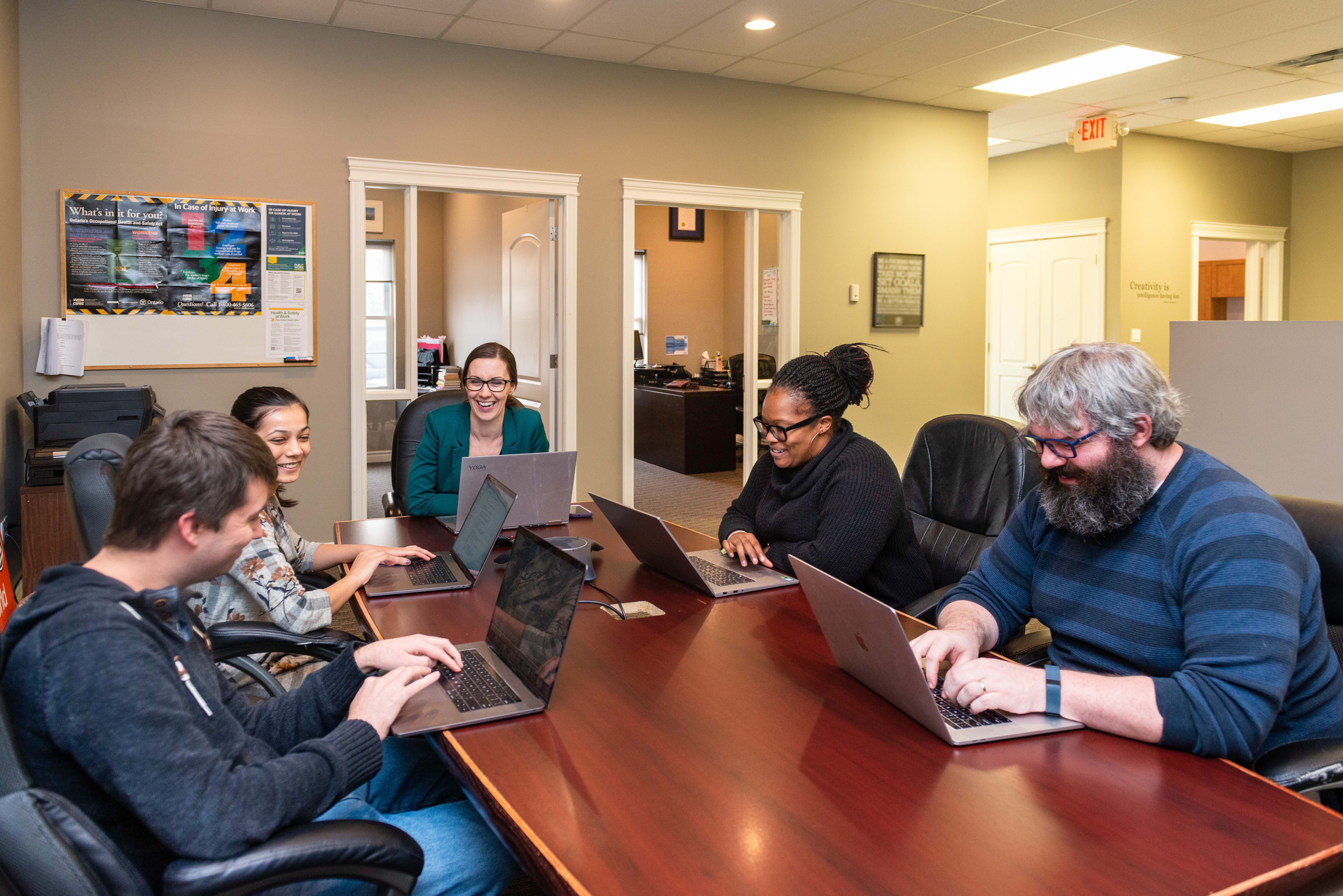 Link2Feed staff working together at a conference table