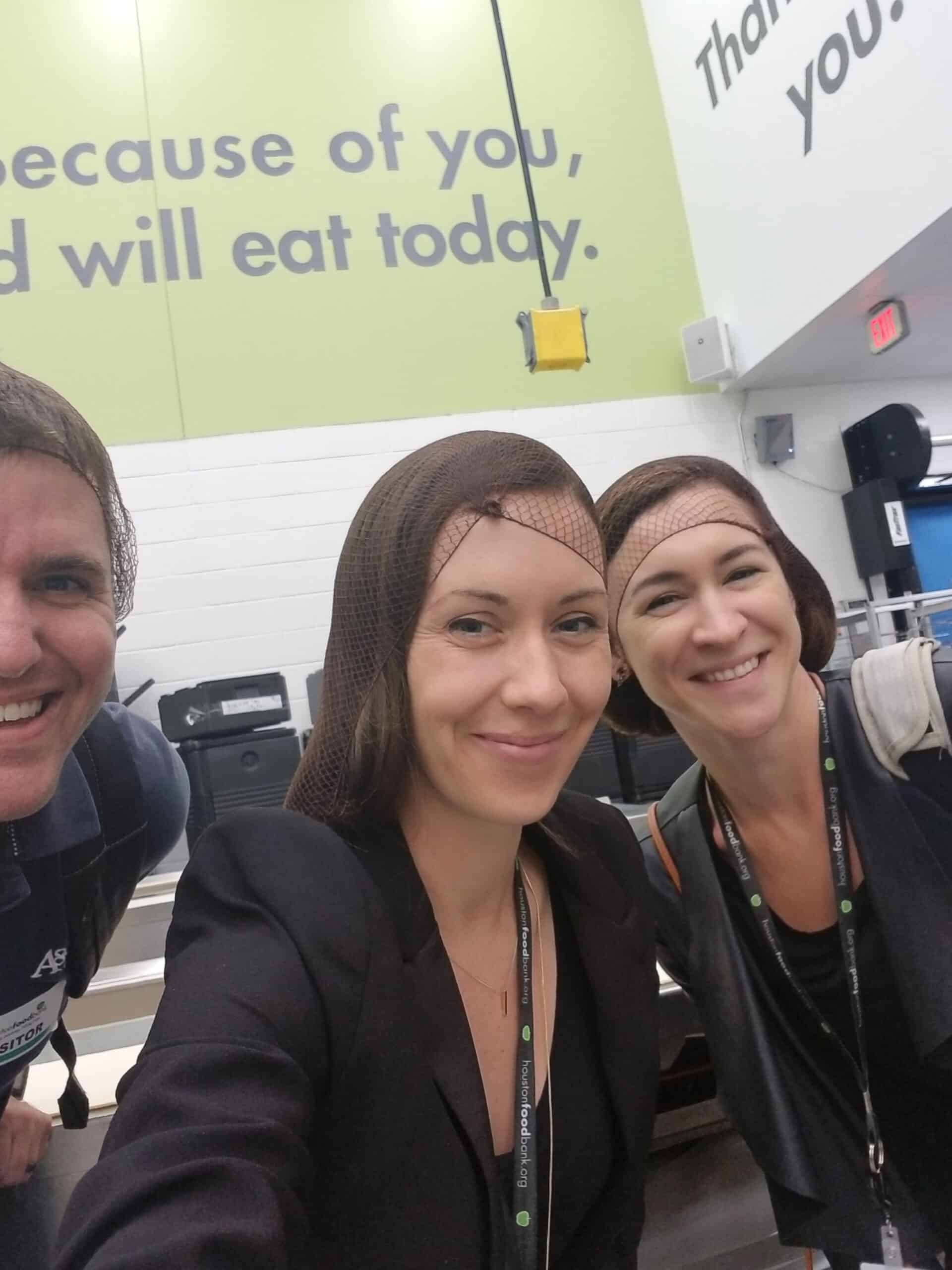 Add on- Volunteer Management- Benefits Image The Link2Feed team volunteering at an organization wearing hair nets